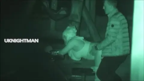 Blonde Couple Kissing at Night