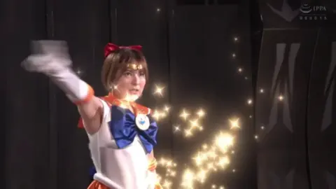 Asian Cosplay Duo in Dimly Lit Setting