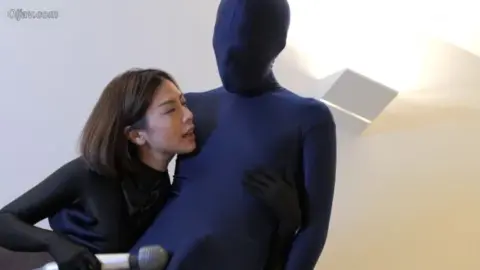 Asian Women in Spandex Suits Embracing