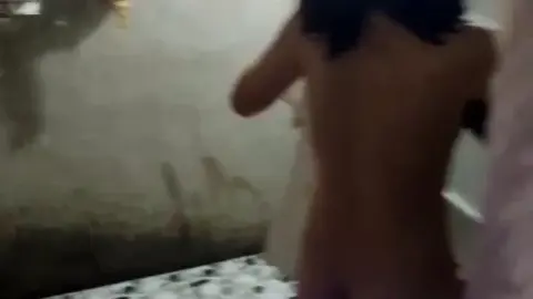 Asian Girl Getting Dressed in Bathroom