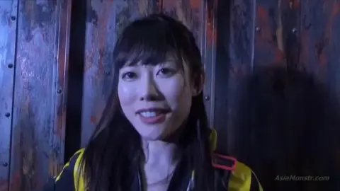 Asian Performers in Costumes Engage in Fighting Poses