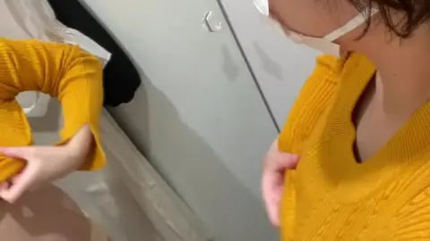 Asian Girl Tries On Clothes in Fitting Room