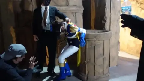 Asian Costumed Performer in Dramatic Scenes