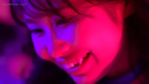 Asian Women in Bodysuits Engage in Erotic Play