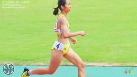 Asian Athletes in Sports Bras Running on Track