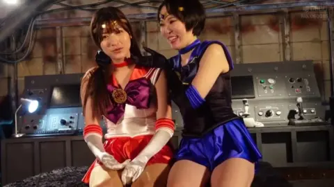 Asian Cosplay Girls Intimate Moment in Sci-Fi Setting