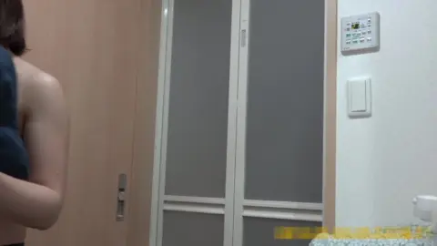 Asian Brunette Undressing in Bedroom