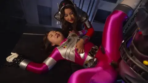 Asian Women in Futuristic Costumes Engage in Intimate Encounter