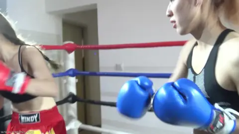 Blonde Women Boxing in Ring