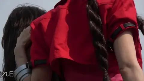 Asian girl in black leather skirt outdoors