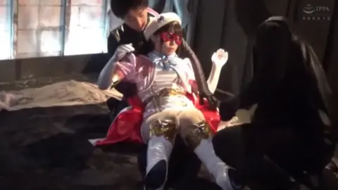 Costumed Performers in Erotic Poses