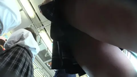 Asian girl exposes herself on public transport