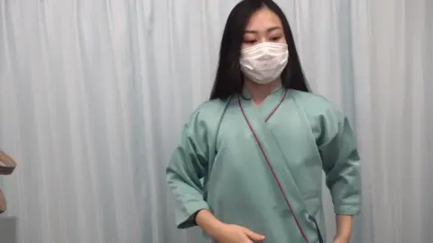 Asian Woman in White Face Mask Unveils Topless