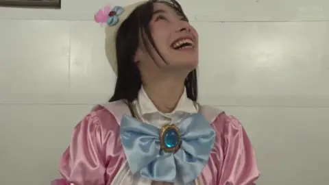 Asian Women in Pink Costumes Posing Indoors