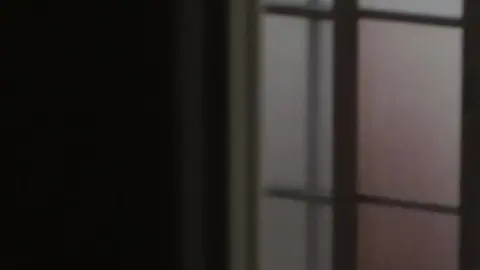 Asian Teen in Dimly Lit Bathroom