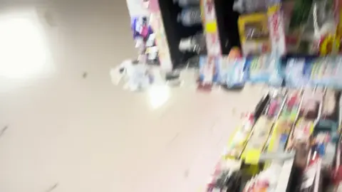 Asian Girls in Plaid Skirts Flirt in Store