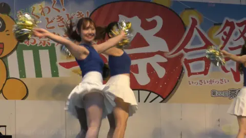 Asian Cheerleaders Dance with Pom-Poms