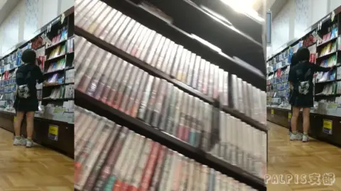 Asian Girl in Black Outfit Explores Bookstore