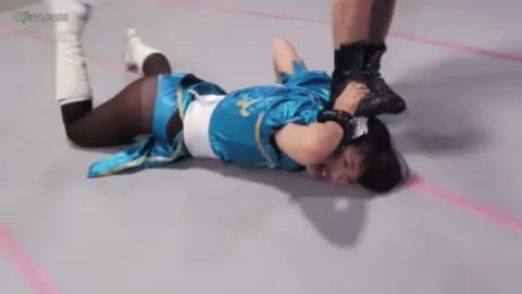 Asian Women Engage in Wrestling Match