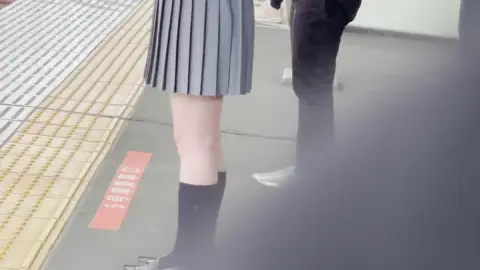 Asian Teen in Gray Skirt and Knee-High Socks