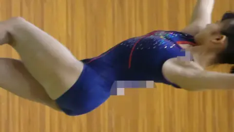 Asian Gymnast in Blue Leotard Performs