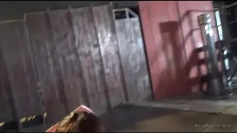 Asian Teen with Bow in Hair and Blonde Ponytail in Industrial Setting