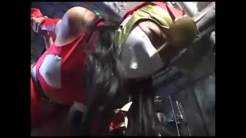 Women in latex and costume engage in intense interaction