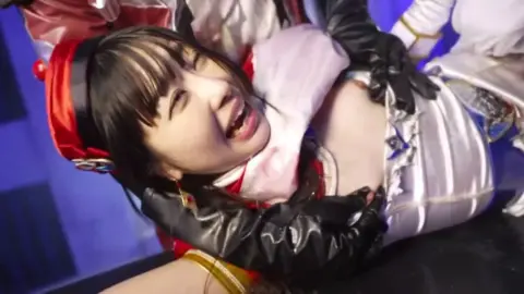 Asian Duo in Red and White Costumes Perform Intimate Scene