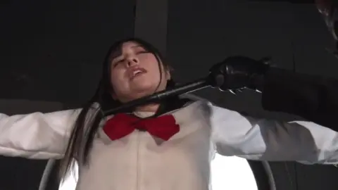 Asian Girl in Red Costume with Gun