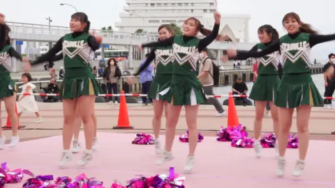 Asian Teen Cheerleaders Outdoor Performance