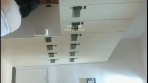 Asian Couple in Hotel Hallway