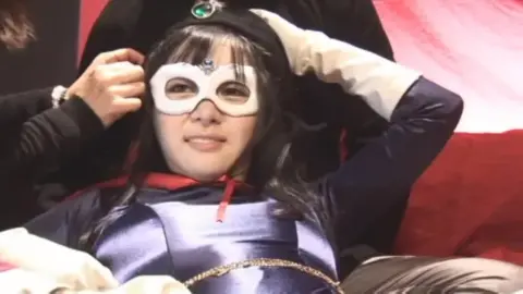 Masked Woman Wields Sword