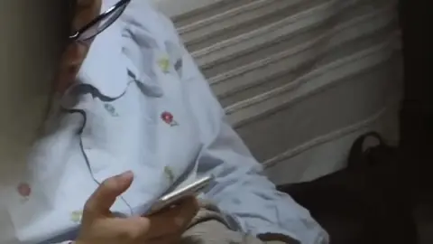 Asian Girl with Glasses in Bedroom