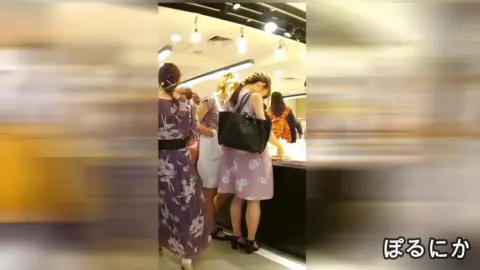 Asian Models Trying On Clothes in Dressing Room