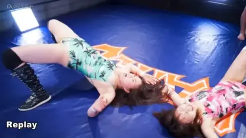 Asian Wrestlers Engage in Intense Grappling Match