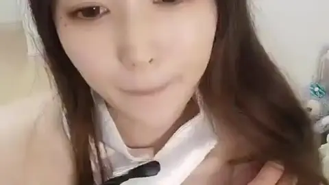 Asian Teen with Bunny Ears in Bedroom