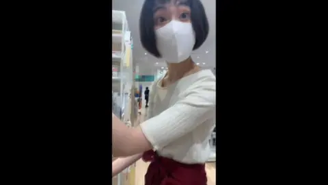 Asian Teen in Red Apron and Mask