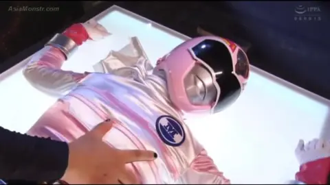 Asian Girl in Costume with Nail Polish in Erotic Scene