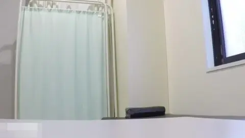 Asian Couple in Bathroom and Medical Office