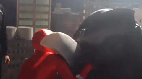 Asian Performer in Red Spandex Suit