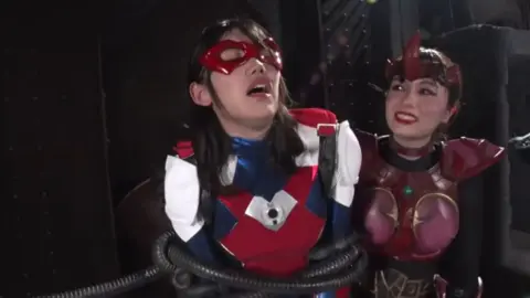 Asian Lesbians in Costumes Engage in Erotic Play