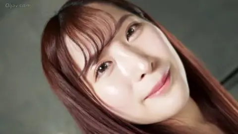 Asian Wrestlers in Red Tops Embrace