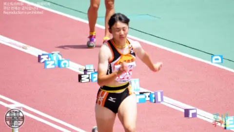 Asian Athletes in Action on the Track