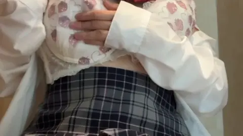 Asian Teen with Pigtails in Bathroom