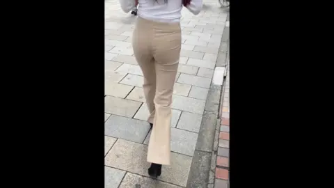 Dark-Haired Girl Walking Indoors and Outdoors