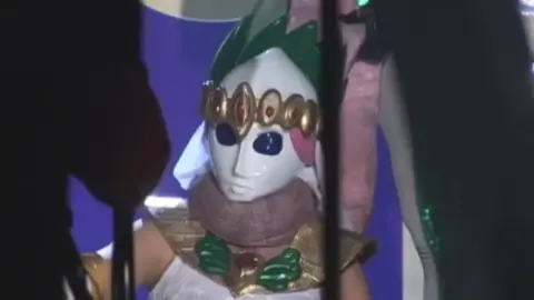 Asian Performer in White Costume and Mask