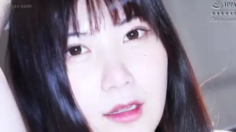 Intimate Act Between Young Couple on Bed