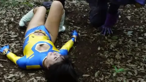 Asian Couple in Costumes Outdoor Encounter