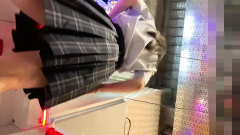 Asian Girl Masturbates in Neon-Lit Arcade