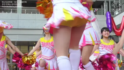 Asian Cheerleaders Dancing in Public